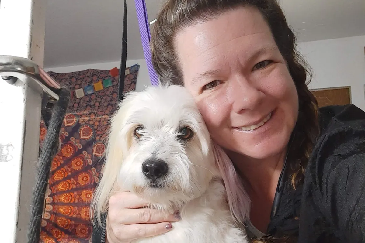 Shanti hugging a white dog